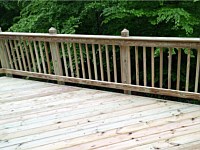 <b>Wood deck in a diagonal pattern with wood railing</b>
